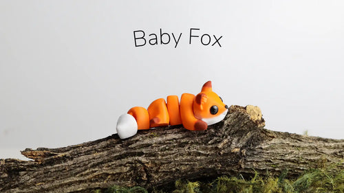 Full view of the orange Baby Fox on bark, creator photograph