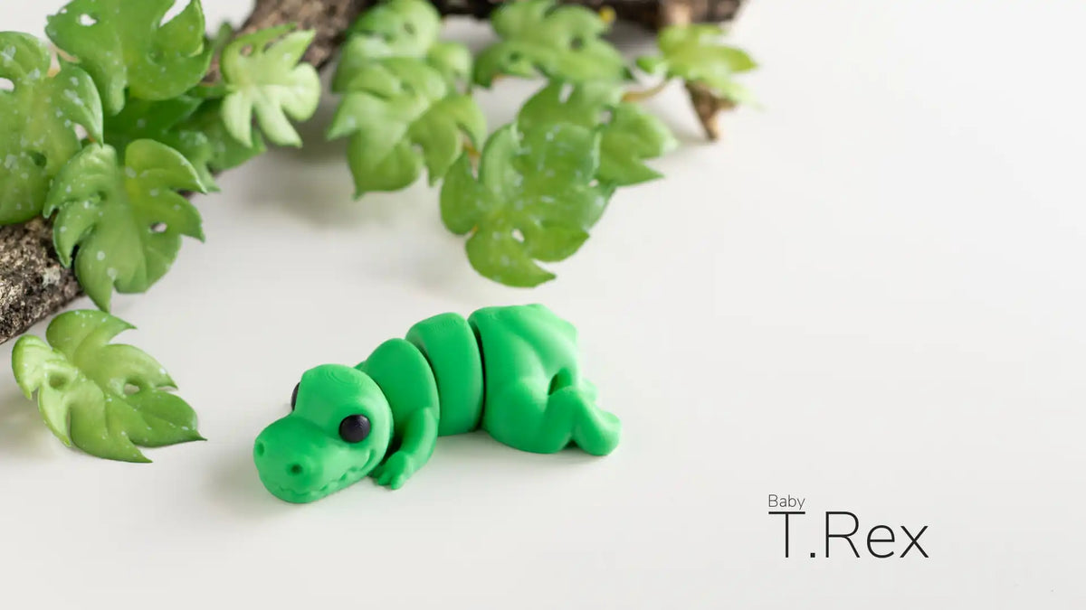Full view of the green Baby T-Rex design, creator photograph